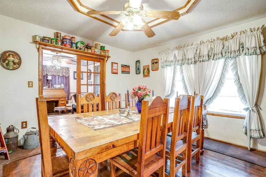 Dining space with wood finished floors, ceiling fan, and a textured ceiling Dining space with wood finished floors, ceiling fan, and a textured ceiling