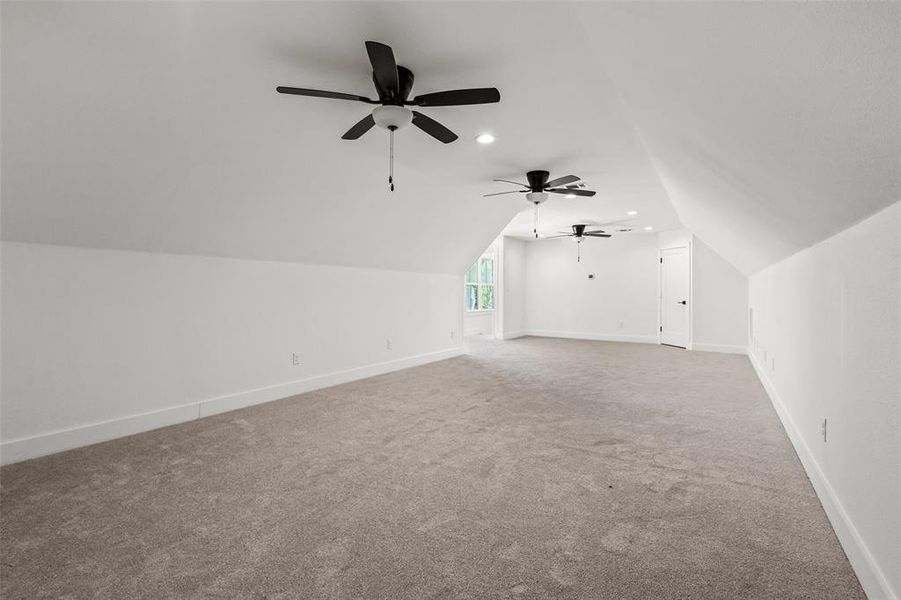 Bonus room with lofted ceiling, carpet floors, ceiling fan, and recessed lighting Bonus room with lofted ceiling, carpet floors, ceiling fan, and recessed lighting