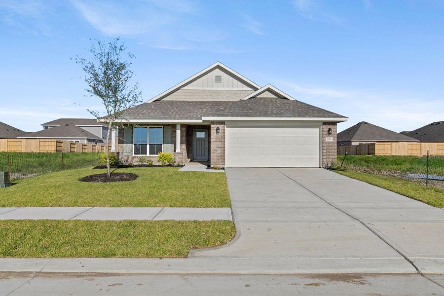 Front exterior of a new home in River Ranch Trails, Dayton, TX, highlighting curb appeal (Image 1).