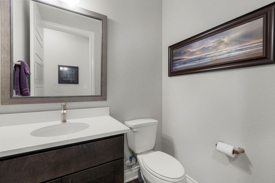 A well-appointed powder room with a sleek vanity and convenient commode.