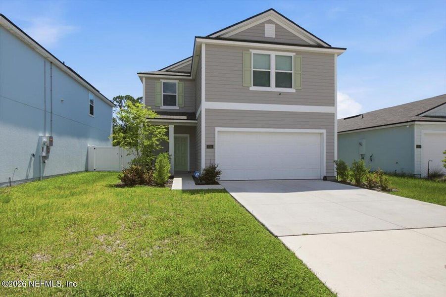 Front exterior of a new home in Ravenswood Village, St. Augustine, FL, highlighting curb appeal (Image 2). Front exterior of a new home in Ravenswood Village, St. Augustine, FL, highlighting curb appeal (Image 2).