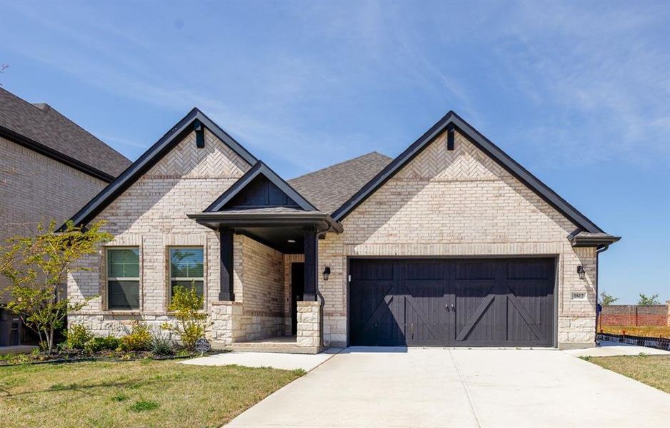 Front exterior of a new home in Valencia on the Lake, Little Elm, TX, highlighting curb appeal (Image 1). Front exterior of a new home in Valencia on the Lake, Little Elm, TX, highlighting curb appeal (Image 1).