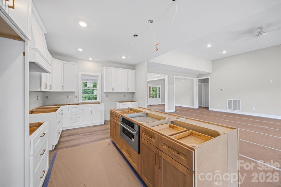 Kitchen island will feature waterfall edge countertops.