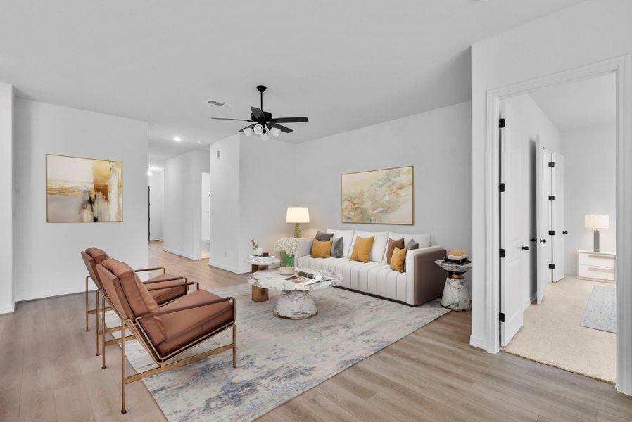 nviting living room featuring high ceilings, large windows, open to the kitchen for comfort and style.