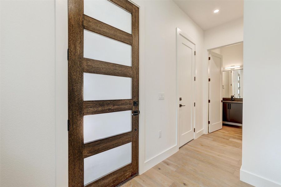 Hallway featuring light wood-type flooring, recessed lighting, and baseboards