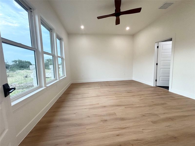 Ample windows invite natural light into this versatile space with warm wood flooring and recessed lighting. Ample windows invite natural light into this versatile space with warm wood flooring and recessed lighting.