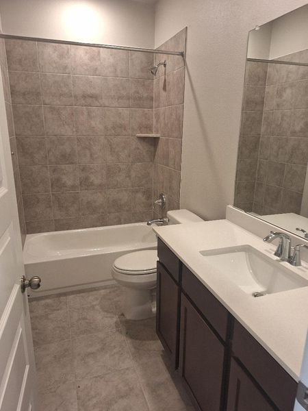 Full bathroom featuring vanity, washtub / shower combination, and tile patterned flooring Full bathroom featuring vanity, washtub / shower combination, and tile patterned flooring
