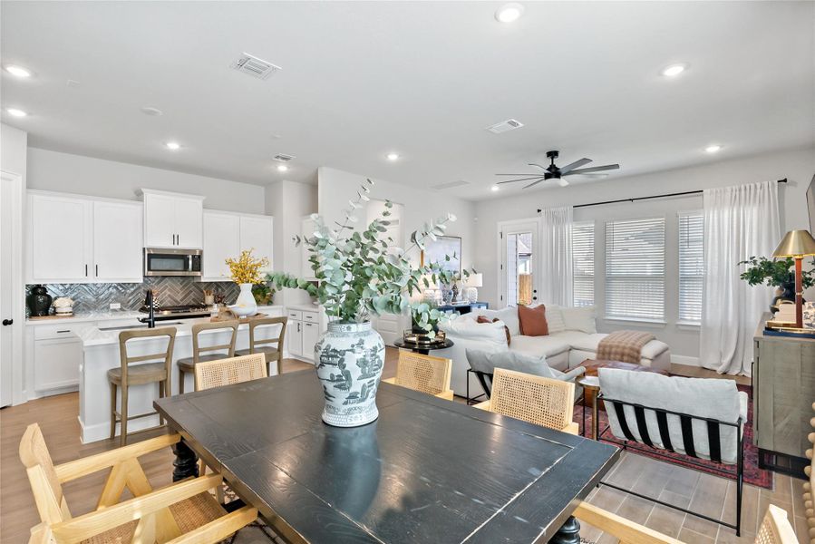 Dining room featuring light wood-style flooring, ceiling fan, and recessed lighting