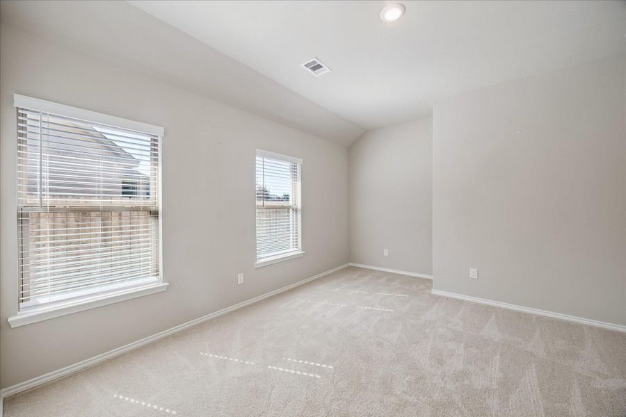 This guest bedroom is spacious and roomy with an en suite bathroom.