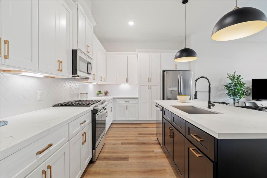 **These photos are of the model unit**Luxury Meets Comfort! Enjoy this bright and airy kitchen featuring two-tone cabinetry, stylish pendant lighting, and a spacious layout that flows seamlessly into the living area.