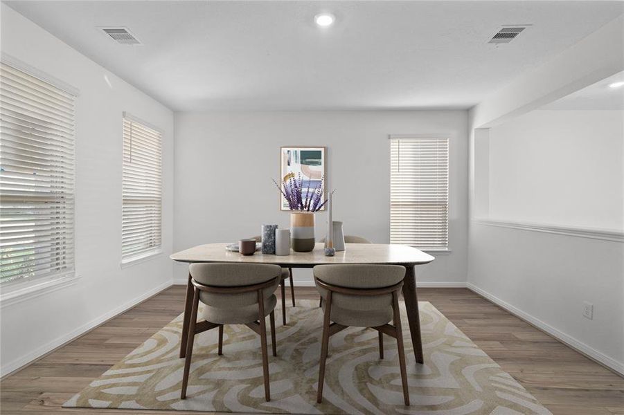 This flex space can be used as a formal dining, office, or den. This room features beautiful flooring, warm paint, recessed lighting, and windows with privacy blinds