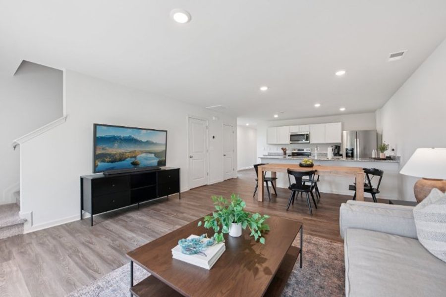 A living room with a tv and a table.