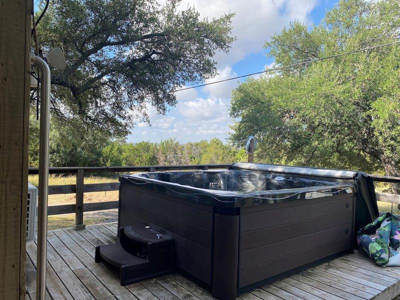 Wooden terrace featuring a hot tub