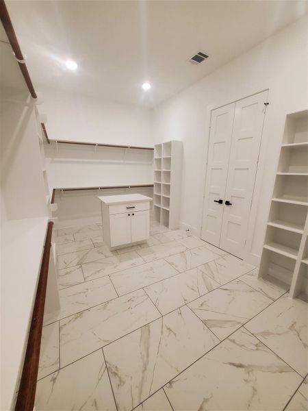 PRIMARY CLOSET WITH OFF-SET ISLAND FOR EXTRA STORAGE PRIMARY CLOSET WITH OFF-SET ISLAND FOR EXTRA STORAGE