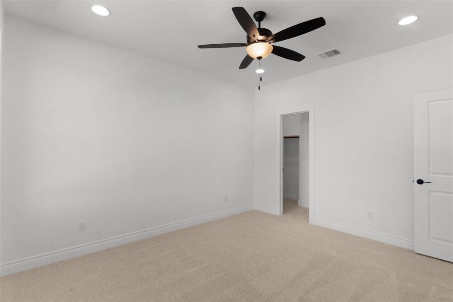 Well-lit sleeping quarters featuring recessed lighting and a ceiling fan for comfort.