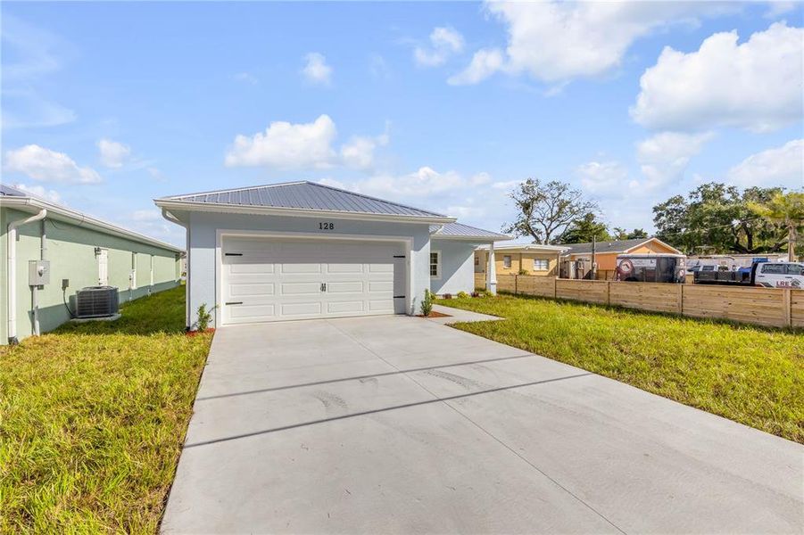 Front exterior of a new home in , Oak Hill, FL, highlighting curb appeal (Image 26).