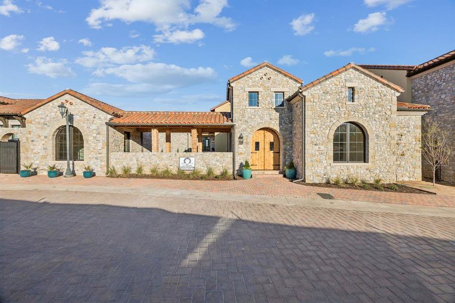 Mediterranean / spanish-style home featuring stone siding and a tiled roof
