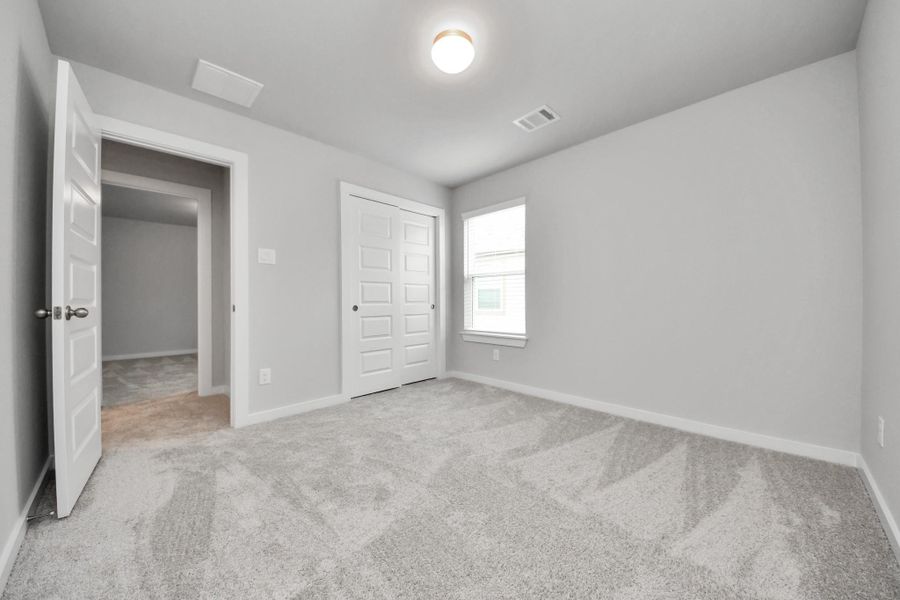 A perfect blend of functionality and comfort. Capture the essence of easy living with a first-floor laundry room, thoughtfully equipped with shelving for effortless organization. Both electric and gas connections available. Sample photo of completed home with similar floor plan. Actual colors and selections may vary.