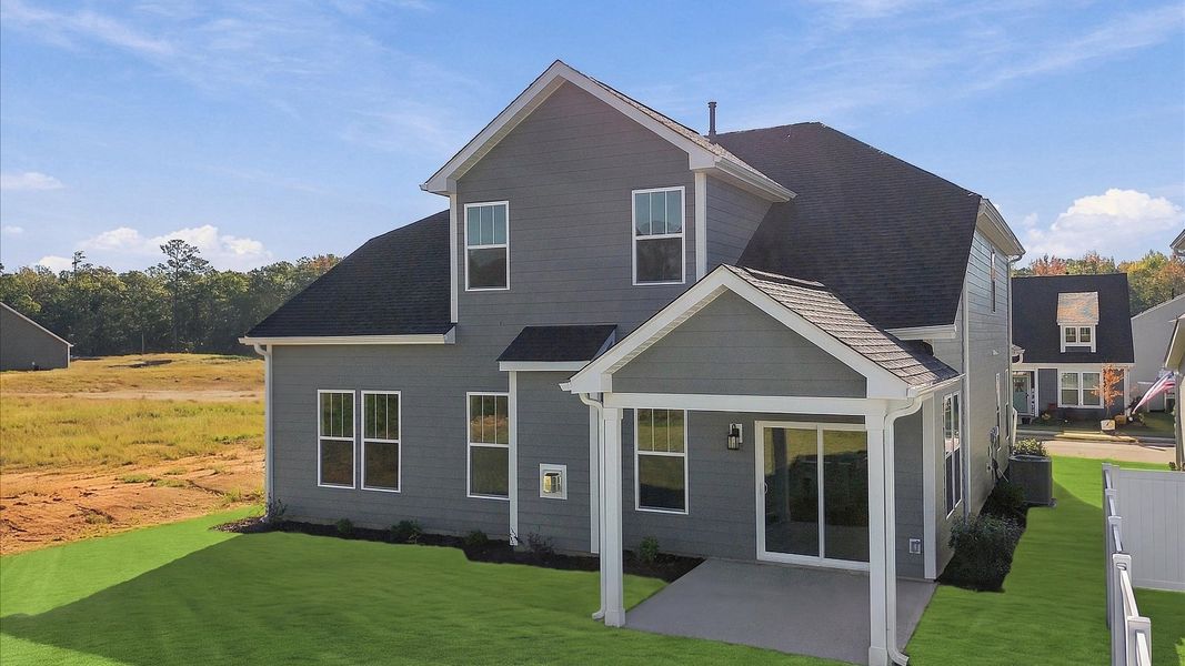 Warm and inviting outdoor living space with a covered rear porch and tasteful finishes at Mulberry Estates