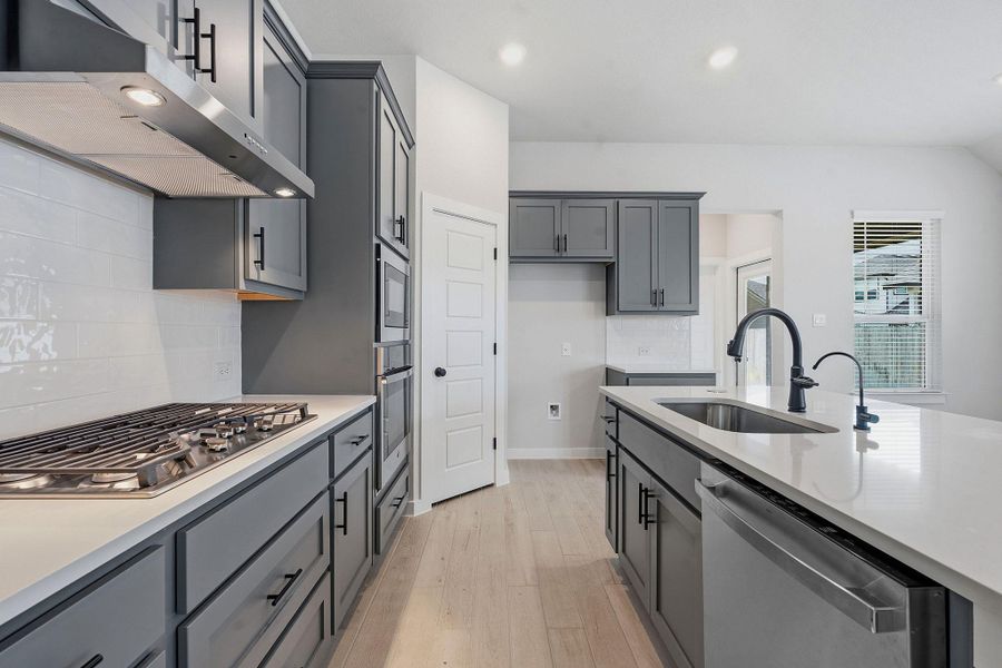 Culinary dreams come alive in this well-appointed kitchen, featuring a gas range and built-in double ovens.