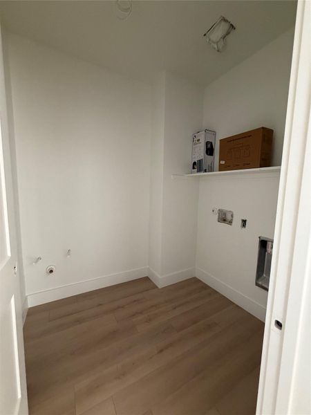 Laundry area featuring wood-style floors and washer hookup
