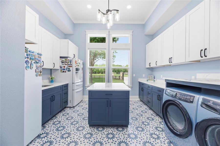 Exceptional scullery room designed with abundant custom storage and expansive prep space.