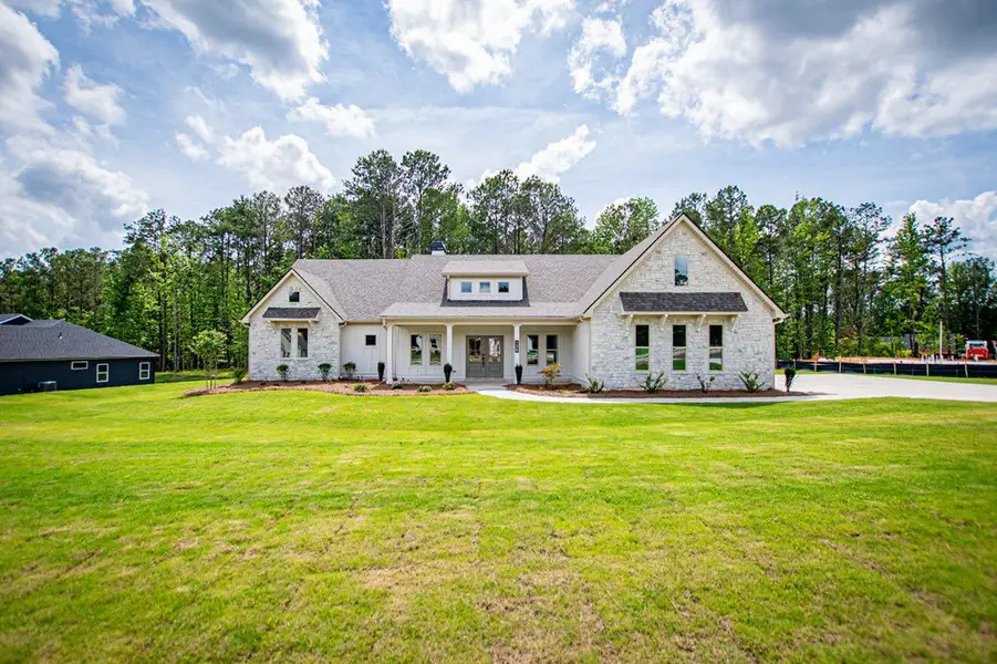Front exterior of a new home in WOODMONT RESERVE, Roopville, GA, highlighting curb appeal (Image 31).