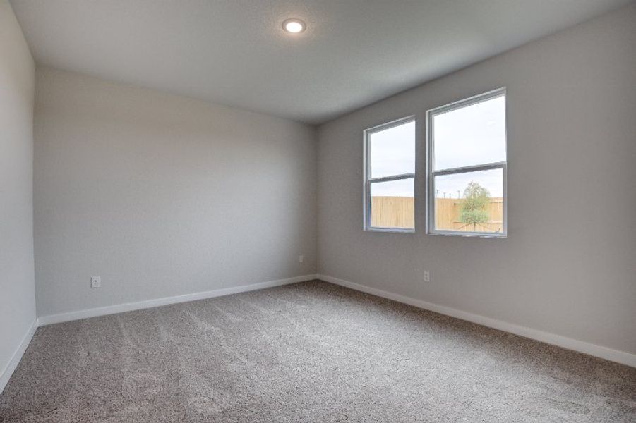A room with a window and carpet.