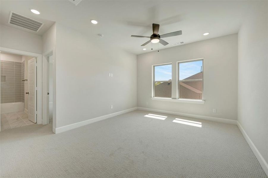 Spare room with light carpet, ceiling fan, and recessed lighting