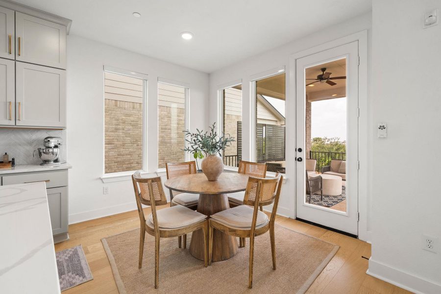 Dining area featuring wood-finish flooring and direct access to an outdoor patio Dining area featuring wood-finish flooring and direct access to an outdoor patio