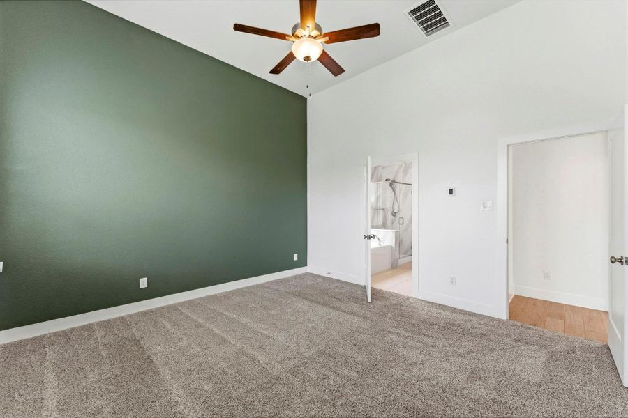 Primary bedroom has an accent wall