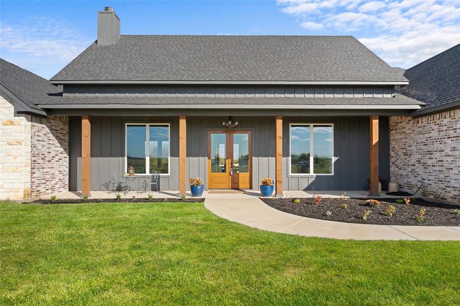Modern farmhouse exterior featuring a stone and brick facade