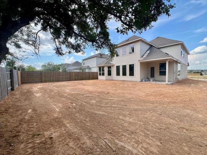 Rear view of house with a patio area, roof with shingles, and a fenced backyard Rear view of house with a patio area, roof with shingles, and a fenced backyard