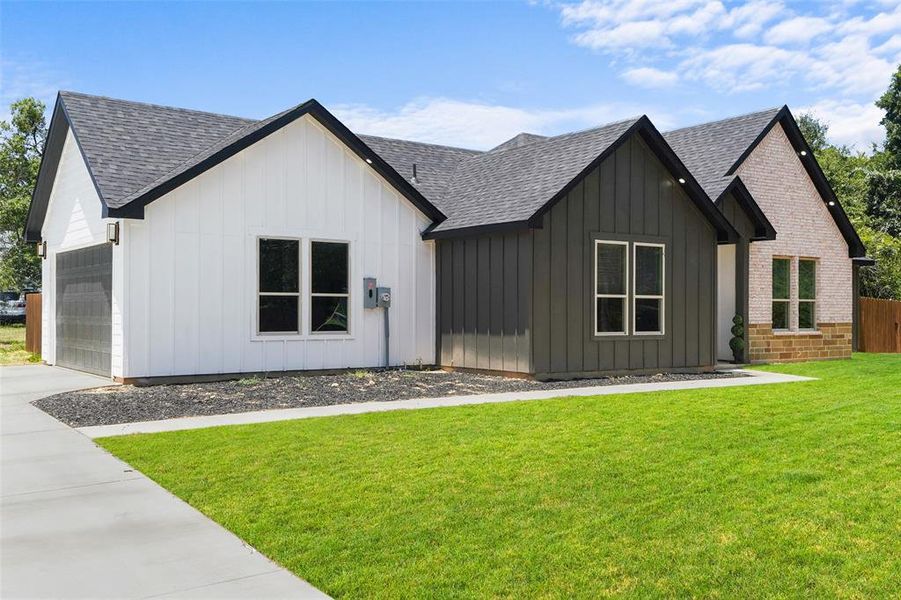 Contemporary exterior featuring a combination of white vertical siding, dark vertical siding, and light-toned brick Contemporary exterior featuring a combination of white vertical siding, dark vertical siding, and light-toned brick