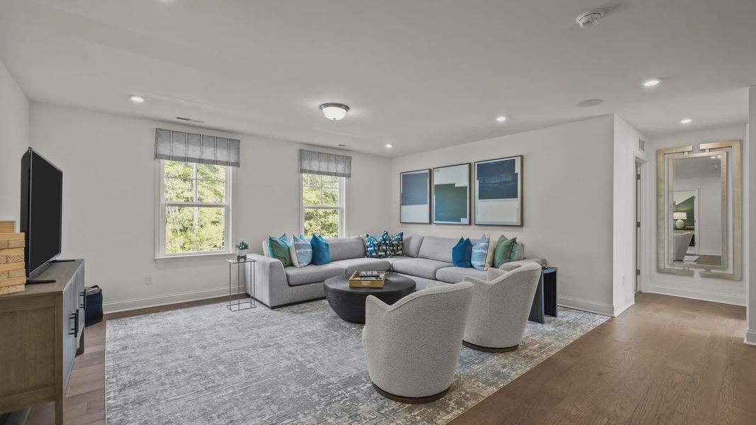 Flexible multi-use loft with elevated ceiling and large windows in the Townsend Design by DRB Homes in York, SC