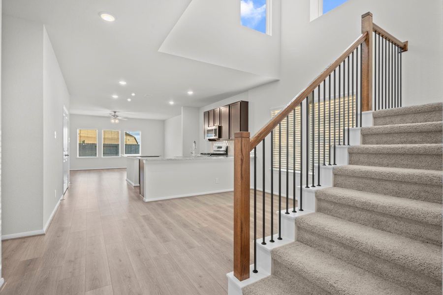 The striking staircase with wrought-iron spindles and rich wooden accents adds a touch of elegance to the open-concept layout. Its placement connects the living, kitchen, and dining spaces beautifully while maintaining an open and inviting feel. Tile that looks like wood floors will lead you into the main living area and more! Let's discover what is upstairs. Better make that call and let me show you this stunning New Construction Home by CastleRock Communities Homes today, let us start memories! The striking staircase with wrought-iron spindles and rich wooden accents adds a touch of elegance to the open-concept layout. Its placement connects the living, kitchen, and dining spaces beautifully while maintaining an open and inviting feel. Tile that looks like wood floors will lead you into the main living area and more! Let's discover what is upstairs. Better make that call and let me show you this stunning New Construction Home by CastleRock Communities Homes today, let us start memories!