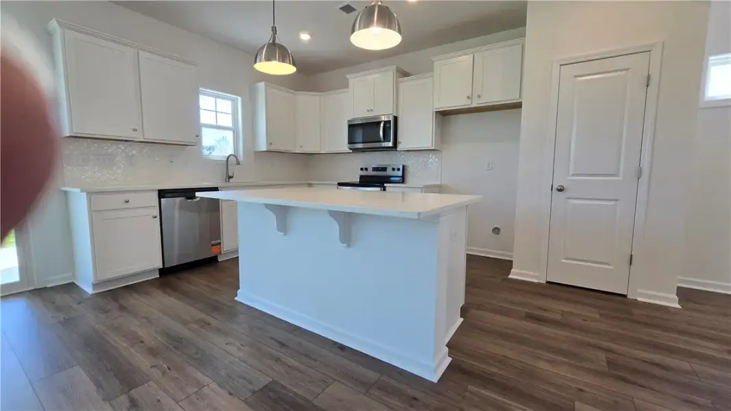 Rich wood-look flooring grounds this culinary spac
