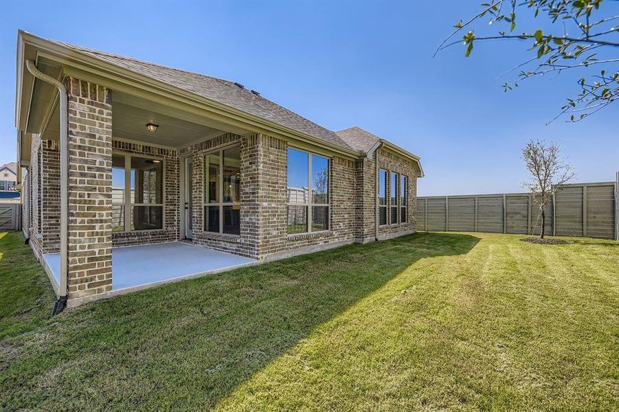 Rear view of property featuring a patio area, brick siding, a shingled roof, and a fenced backyard Rear view of property featuring a patio area, brick siding, a shingled roof, and a fenced backyard