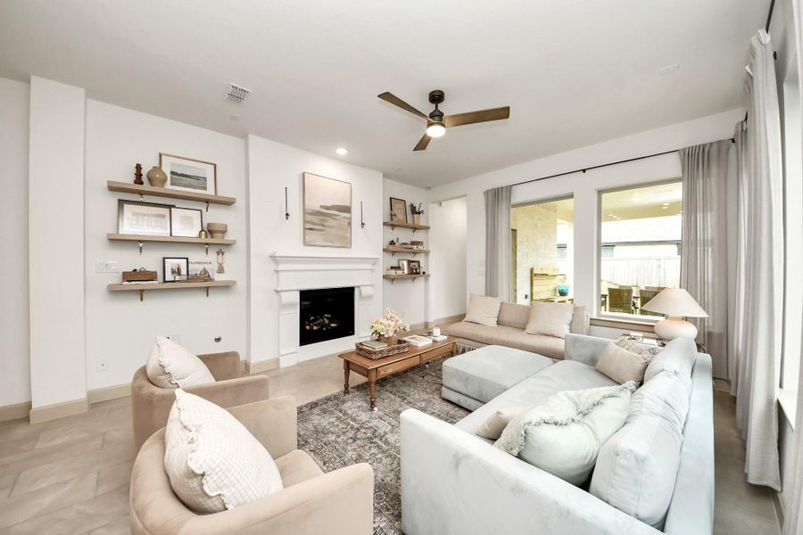 This cozy living room has extra windows for abundant natural light.