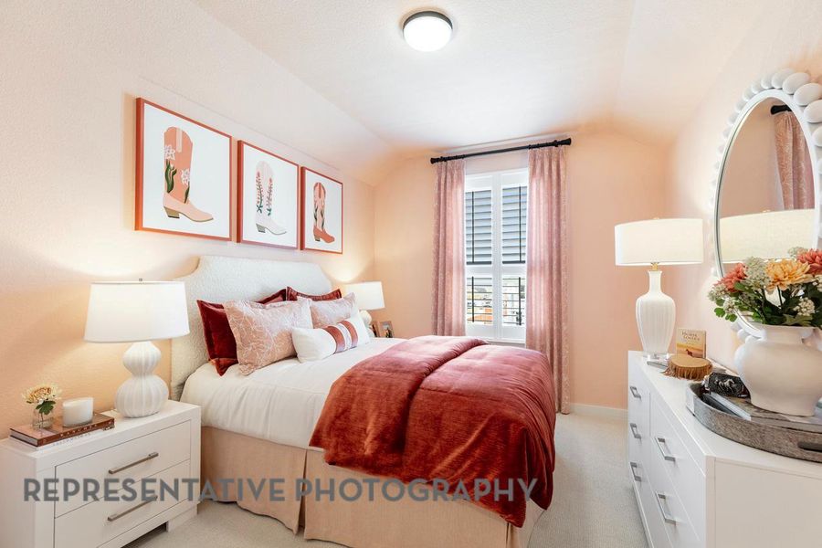 Bedroom featuring vaulted ceiling and light colored carpet