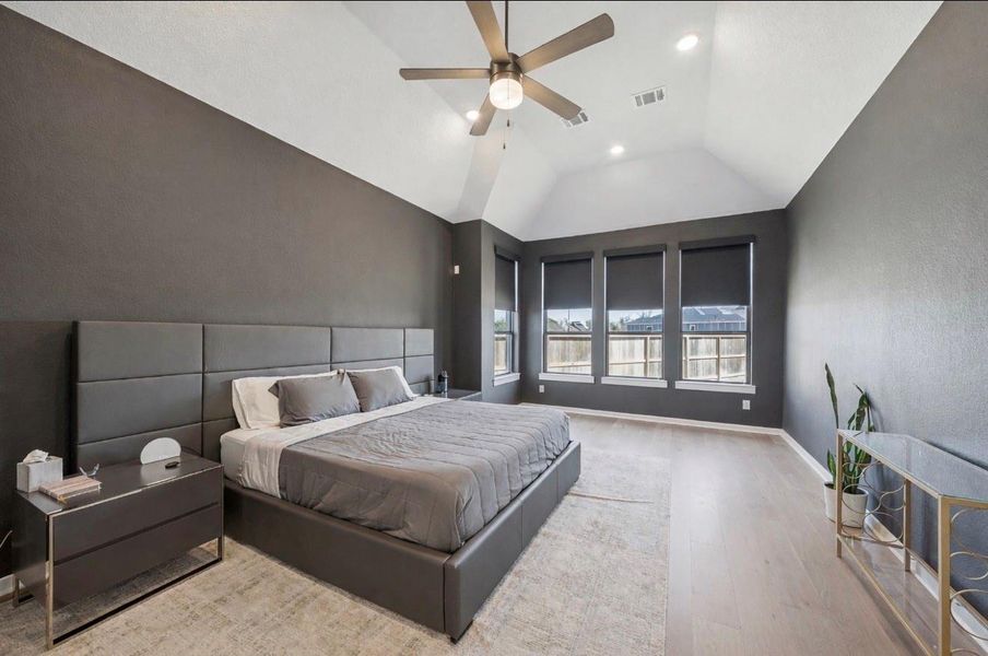 This stunning and primary bathroom is massive with bay windows overlooking the backyard.