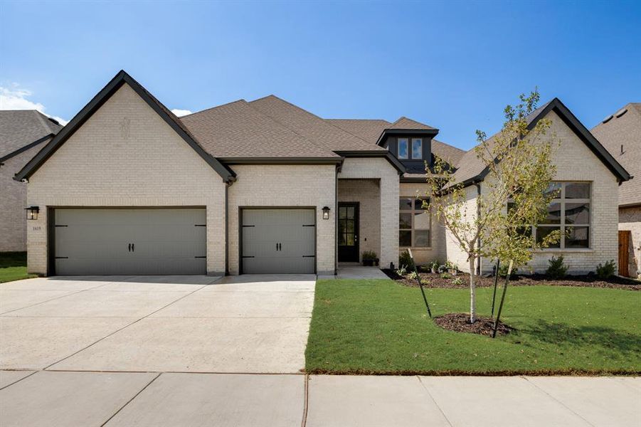 Front exterior of a new home in Monterra - Classics, Fate, TX, highlighting curb appeal (Image 1). Front exterior of a new home in Monterra - Classics, Fate, TX, highlighting curb appeal (Image 1).