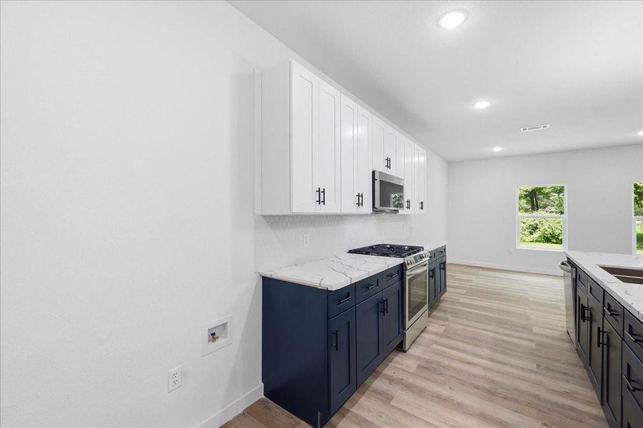 Sleek quartz or solid-surface countertops offer ample workspace alongside premium stainless steel appliances. Sleek quartz or solid-surface countertops offer ample workspace alongside premium stainless steel appliances.