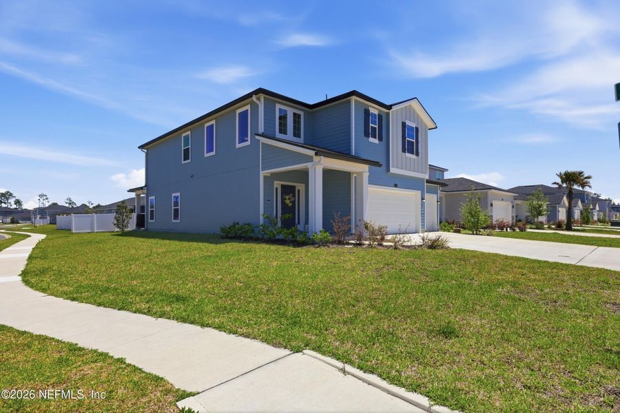 Front exterior of a new home in Cordova Palms, St. Augustine, FL, highlighting curb appeal (Image 1). Front exterior of a new home in Cordova Palms, St. Augustine, FL, highlighting curb appeal (Image 1).