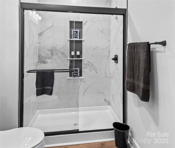 Main Bath with walk in tiled shower.