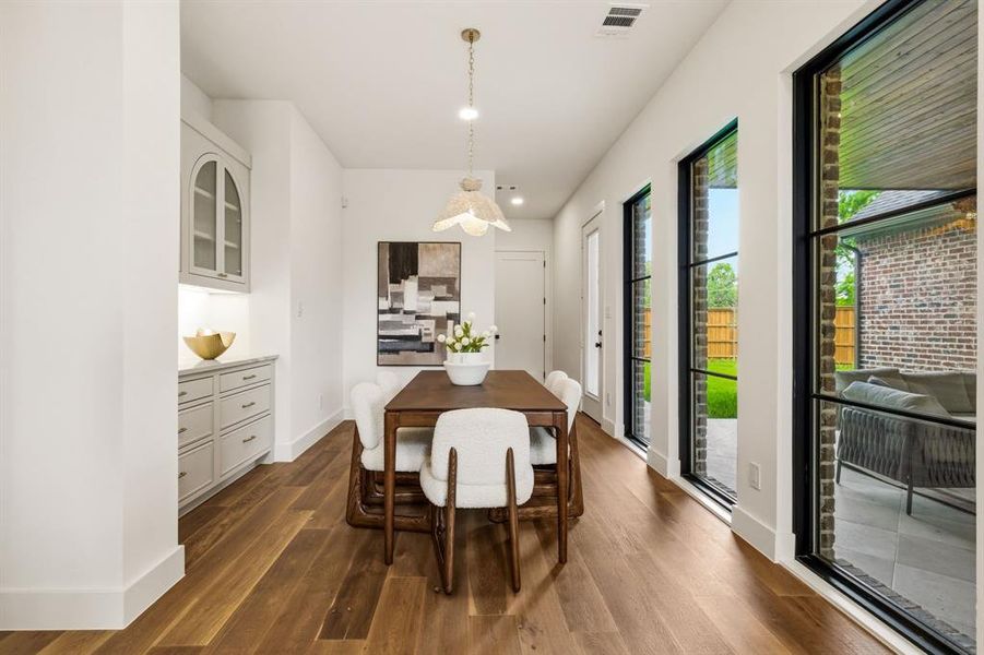 Secondary dining or breakfast nook with dry bar and access to the garage and covered patio