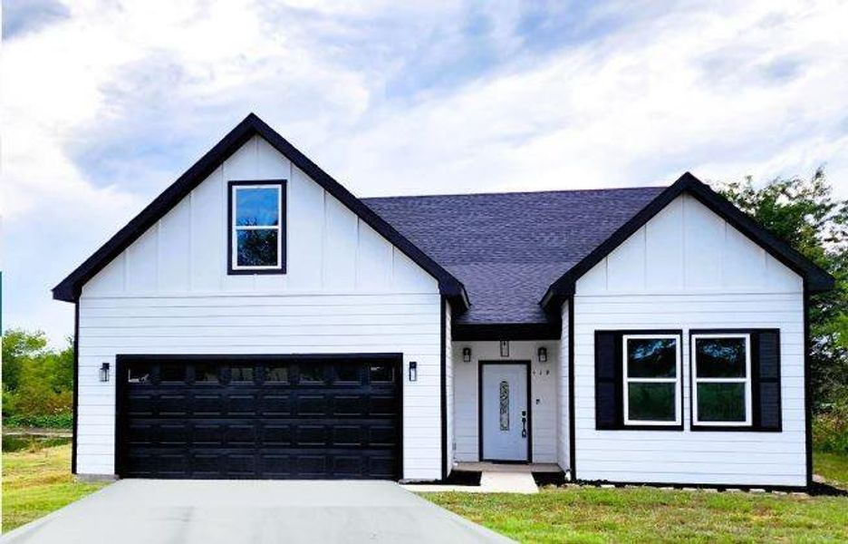 Modern farmhouse style home featuring a garage