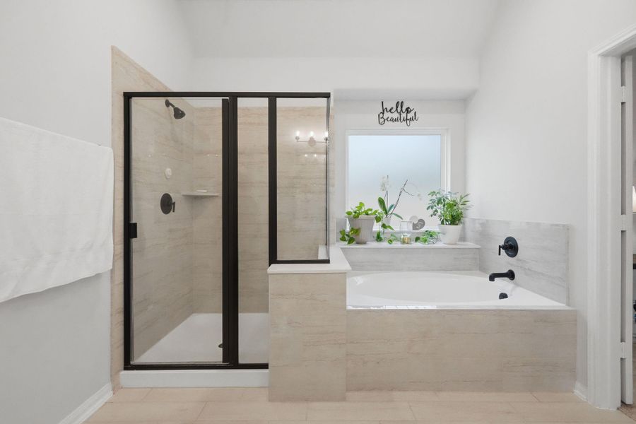 A primary bathroom designed to unwind, featuring a soaking tub, walk-in shower, and space to slow down at the end of the day.