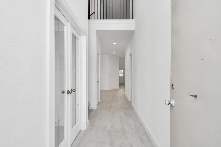 As you step into the threshold of this luxurious home, you'll soon be welcomed by an elegant glass door (to be installed). Inside, soaring ceilings amplify the spaciousness, while the refined wood-look tile flooring and oversized baseboards exude sophistication and charm. Sample photo of completed home with similar floor plan. Actual colors and selections may vary. As you step into the threshold of this luxurious home, you'll soon be welcomed by an elegant glass door (to be installed). Inside, soaring ceilings amplify the spaciousness, while the refined wood-look tile flooring and oversized baseboards exude sophistication and charm. Sample photo of completed home with similar floor plan. Actual colors and selections may vary.