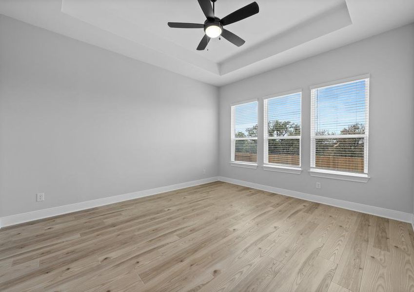 The master bedroom has beautiful, large windows.